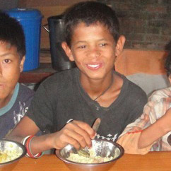 Dawas Ministries boys eating a hot meal at the feeding shelter.